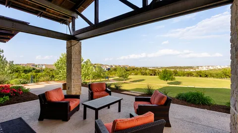 a view of a ocean from a balcony with seating space