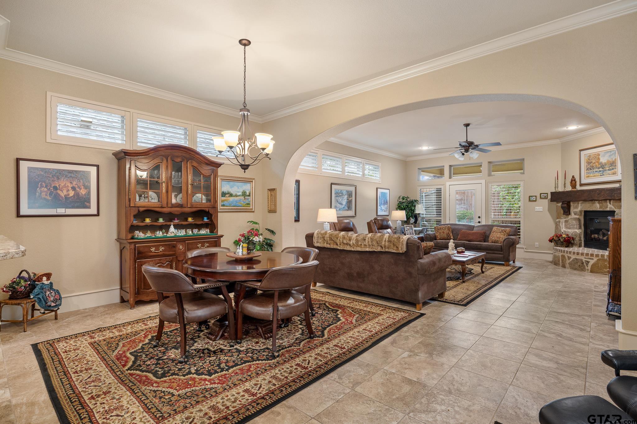 4322 Madera Drive Tyler, TX 75707 - Photo 15 of 32 a living room with furniture a dining table and a chandelier