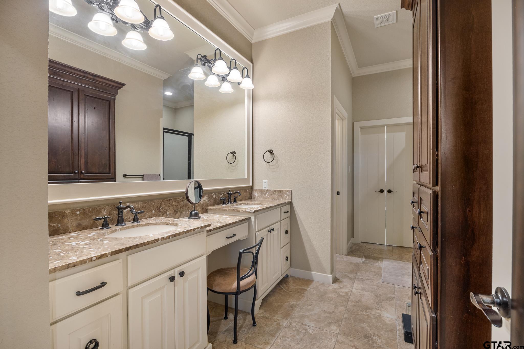 4322 Madera Drive Tyler, TX 75707 - Photo 22 of 32 a bathroom with a granite countertop sink a large mirror and a shower