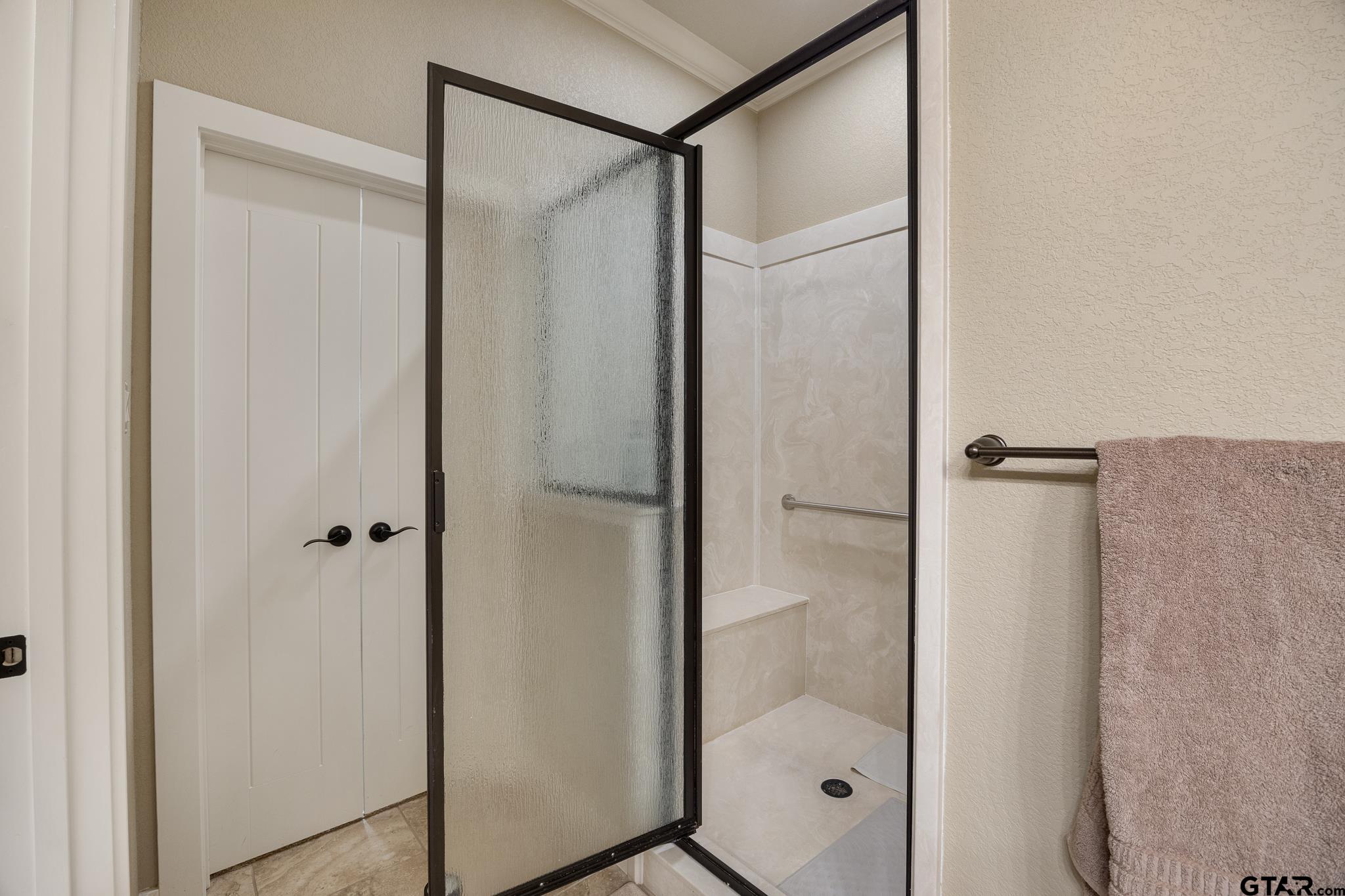 4322 Madera Drive Tyler, TX 75707 - Photo 23 of 32 a bathroom with a glass shower door