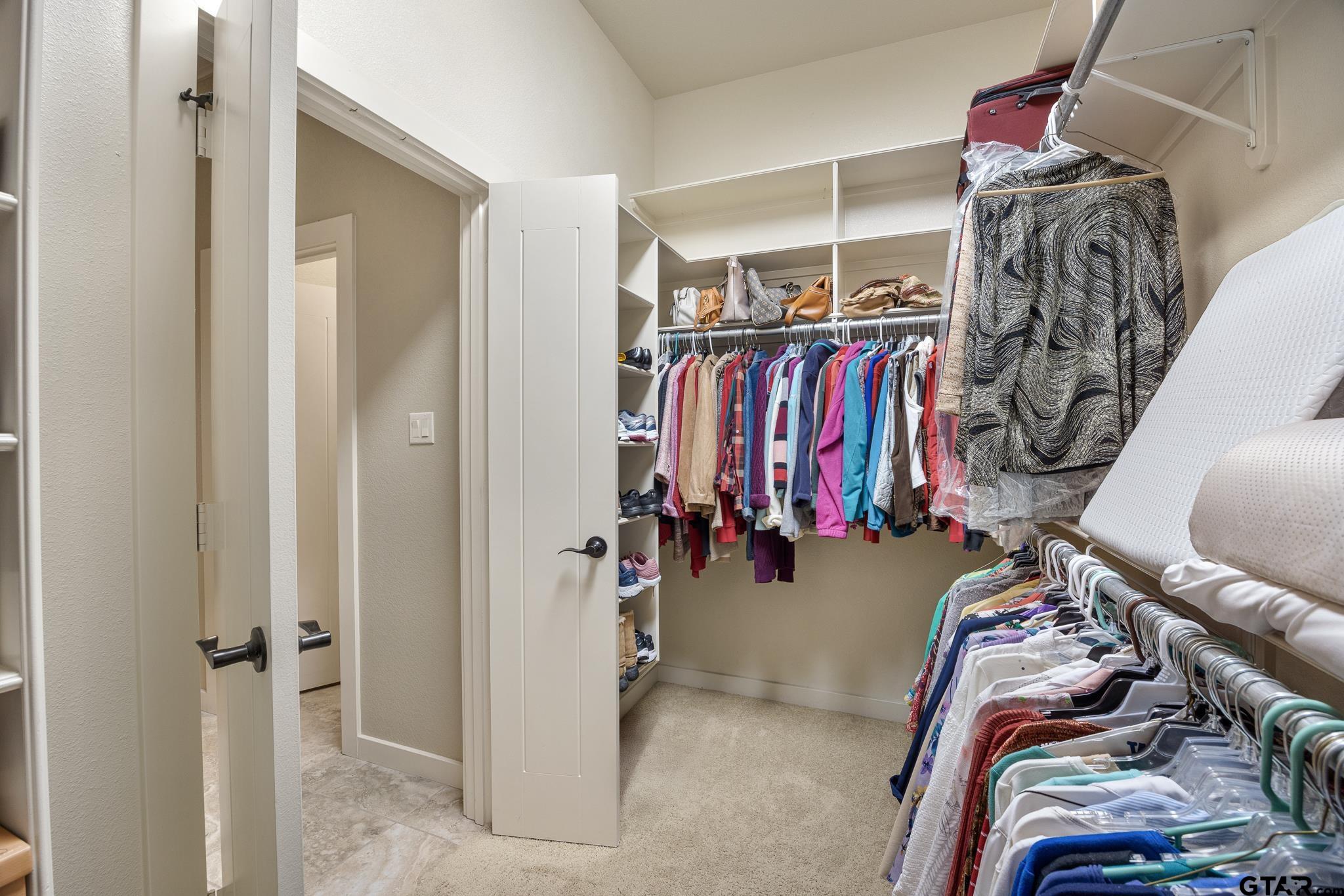 4322 Madera Drive Tyler, TX 75707 - Photo 24 of 32 a view of walk in closet with clothes
