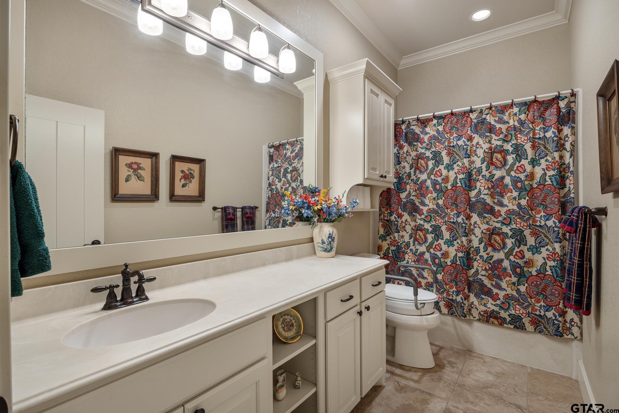 4322 Madera Drive Tyler, TX 75707 - Photo 26 of 32 a bathroom with a sink vanity mirror and toilet