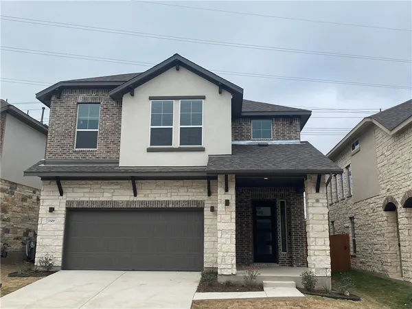 a front view of a house with a garage