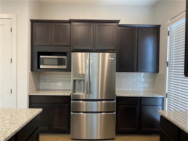 a kitchen with a refrigerator and a sink