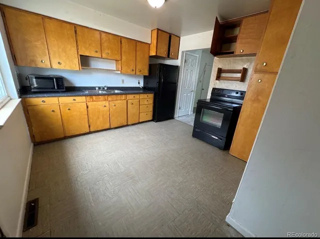 a kitchen with stainless steel appliances a refrigerator and a sink