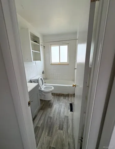 a bathroom with a sink a toilet and a window