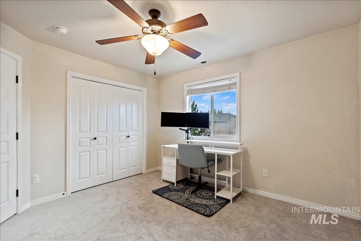 12293 West Murchison Street Boise, ID 83709 - Photo 19 of 27 Office space with light carpet, a textured ceiling, and a ceiling fan