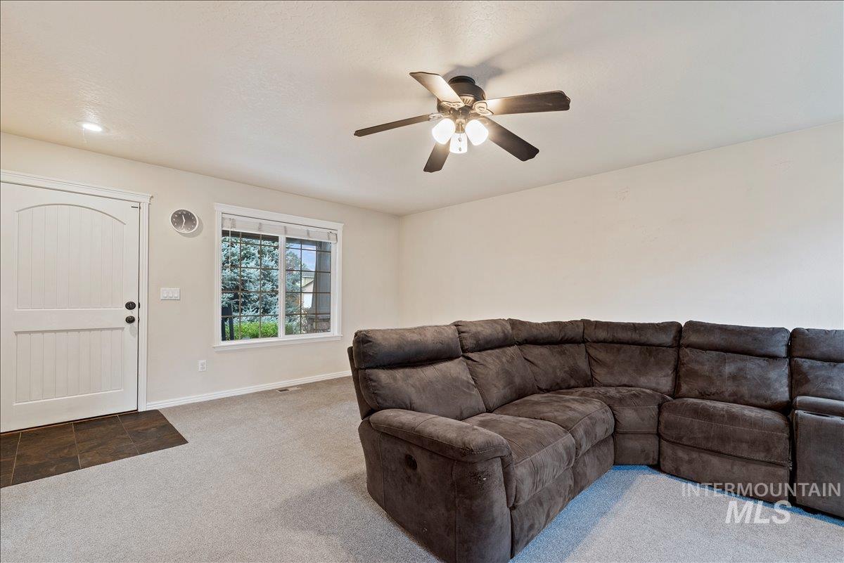 12293 West Murchison Street Boise, ID 83709 - Photo 5 of 27 Living area with carpet and a ceiling fan