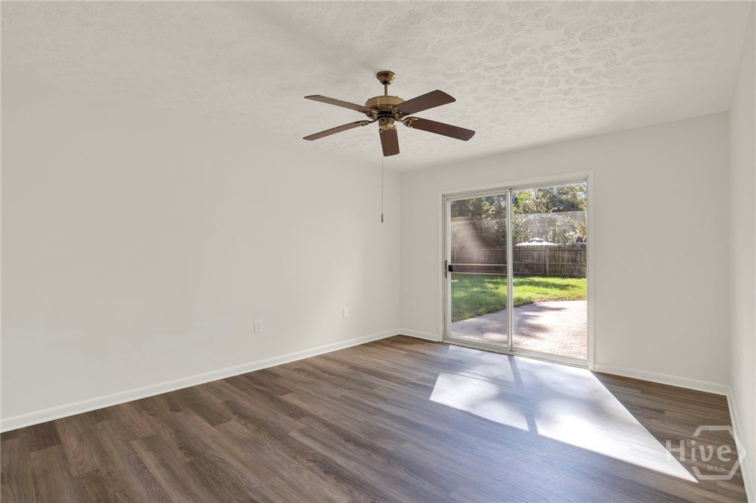 910 Old Mill Road Savannah, GA 31419 - Photo 32 of 41 Primary suite with ceiling fan and glass slider to the rear patio.