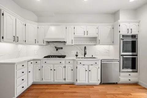 a kitchen with stainless steel appliances granite countertop a stove and a refrigerator