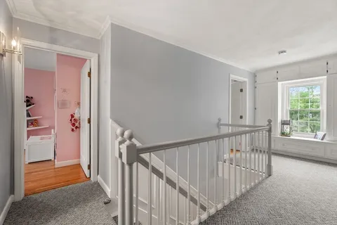 a view of a hallway with a window and stairs