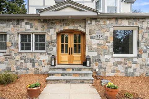a front view of a house with outdoor seating