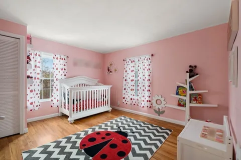 a bedroom with furniture and baby crib