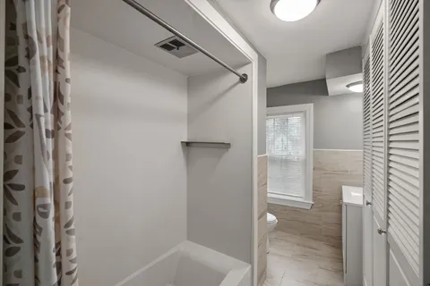 a bathroom with a bathtub and shower