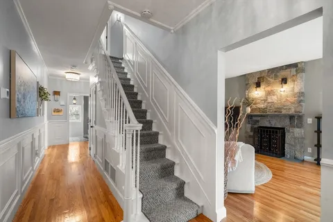 a view of entryway and hall with wooden floor