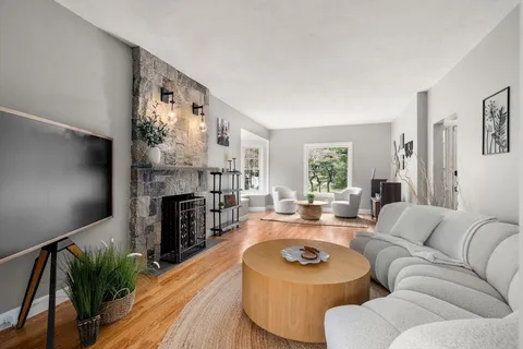 a living room with furniture and a fireplace