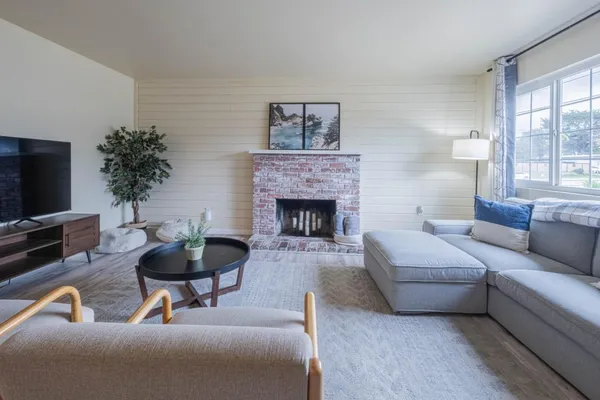 a living room with furniture and a fireplace