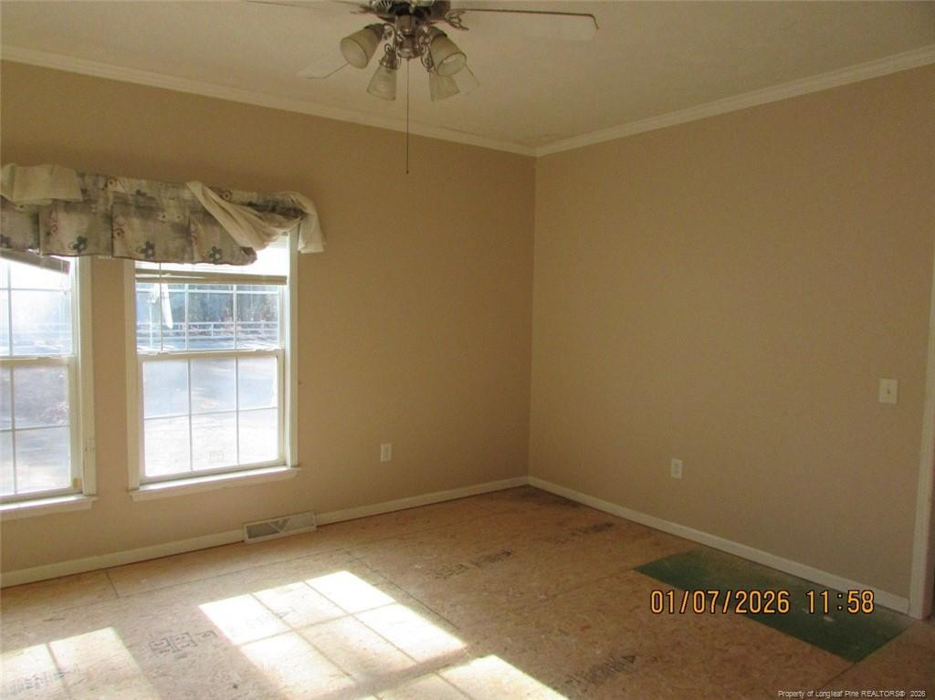 1807 Horseshoe Bend Road Erwin, NC 28339 - Photo 11 of 12 an empty room with a window