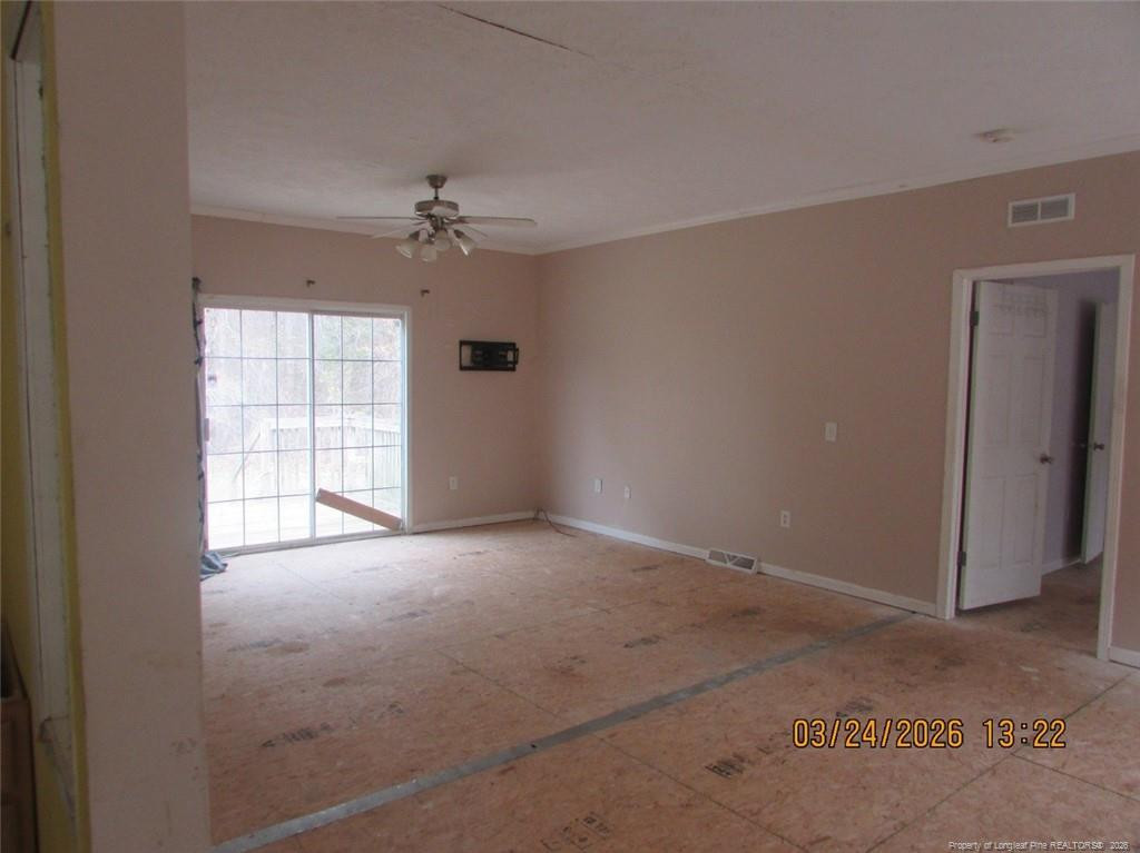 1807 Horseshoe Bend Road Erwin, NC 28339 - Photo 12 of 12 an empty room with windows and ceiling fan