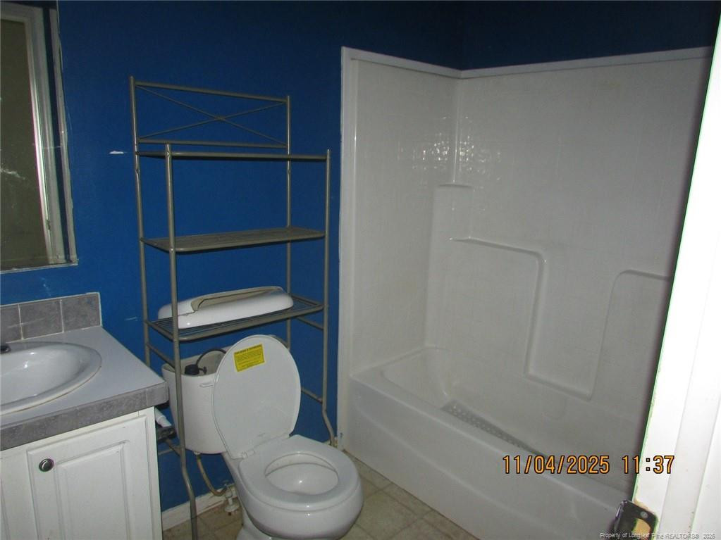1807 Horseshoe Bend Road Erwin, NC 28339 - Photo 5 of 12 a bathroom with a toilet a sink and bathtub
