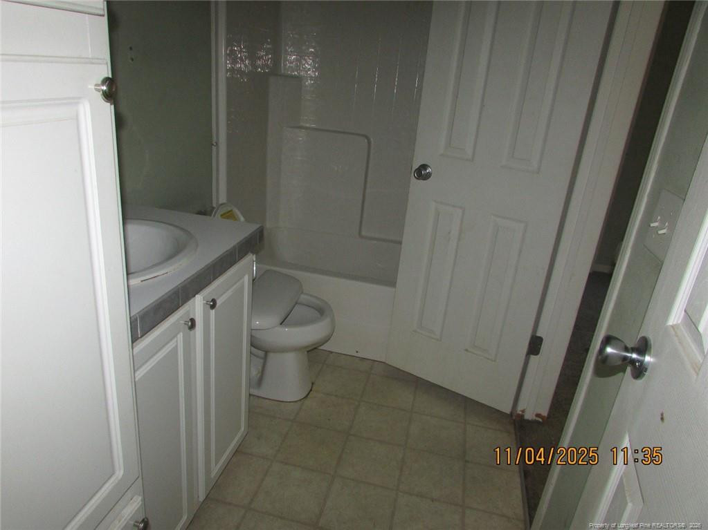 1807 Horseshoe Bend Road Erwin, NC 28339 - Photo 6 of 12 a bathroom with a granite countertop sink toilet and shower