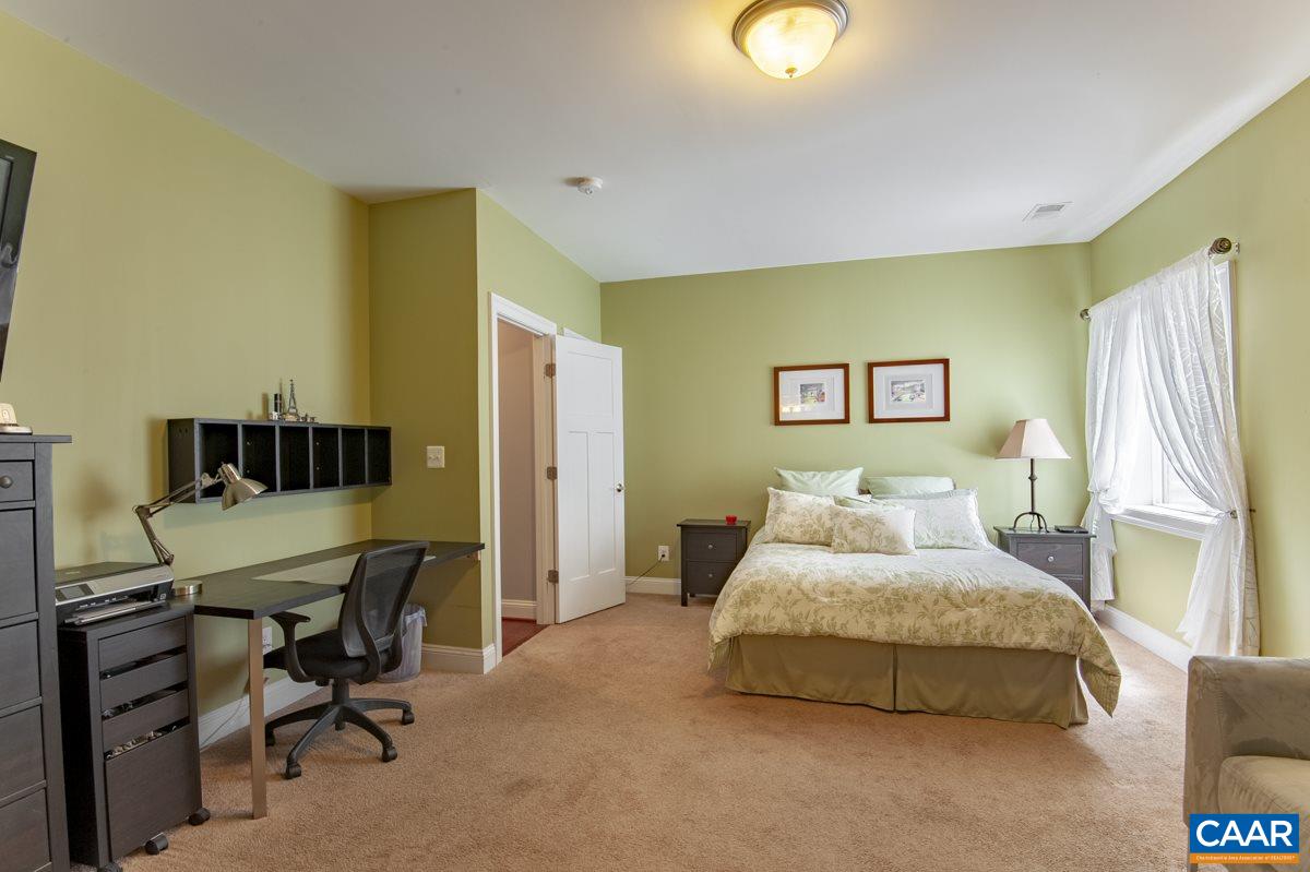2140 Avinity Loop Charlottesville, VA 22902 - Photo 6 of 26 a bedroom with a bed and a chandelier