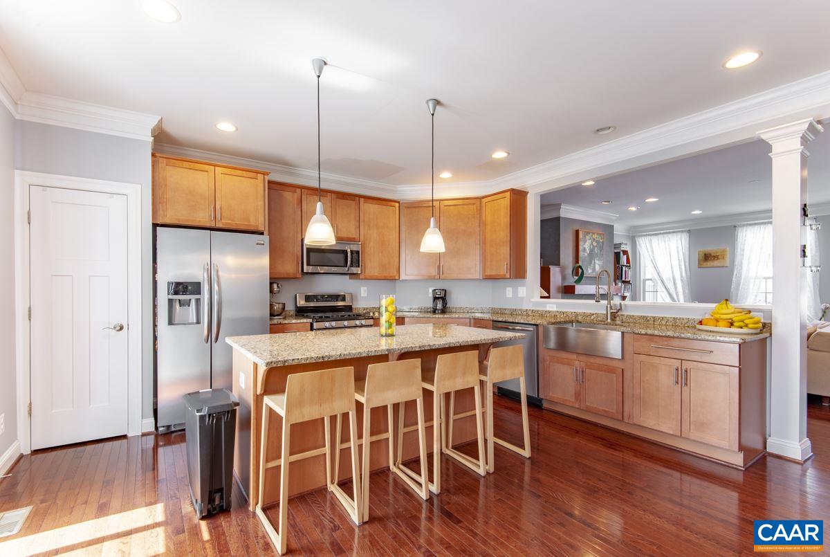 2140 Avinity Loop Charlottesville, VA 22902 - Photo 8 of 26 a kitchen with stainless steel appliances granite countertop a refrigerator a stove top oven a sink dishwasher and white cabinets with wooden floor