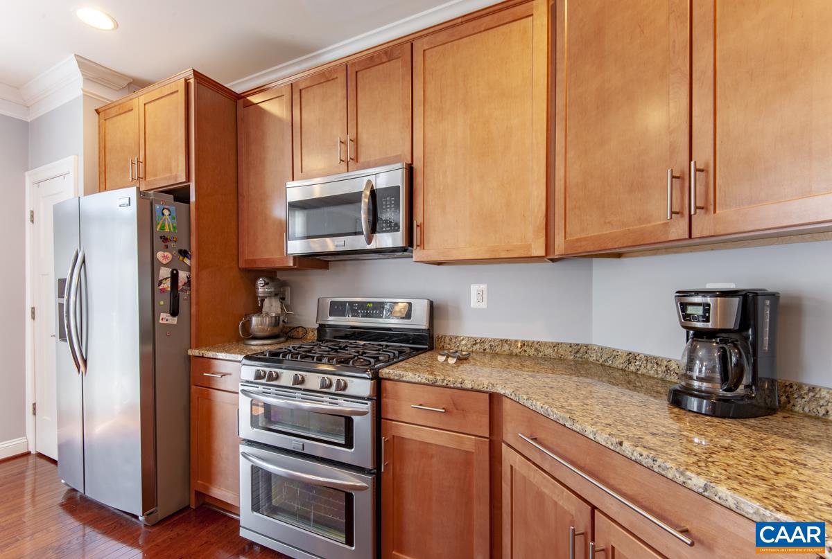 2140 Avinity Loop Charlottesville, VA 22902 - Photo 10 of 26 a kitchen with stainless steel appliances granite countertop a refrigerator stove and cabinets