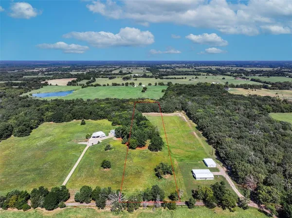 an aerial view of a houses with a yard