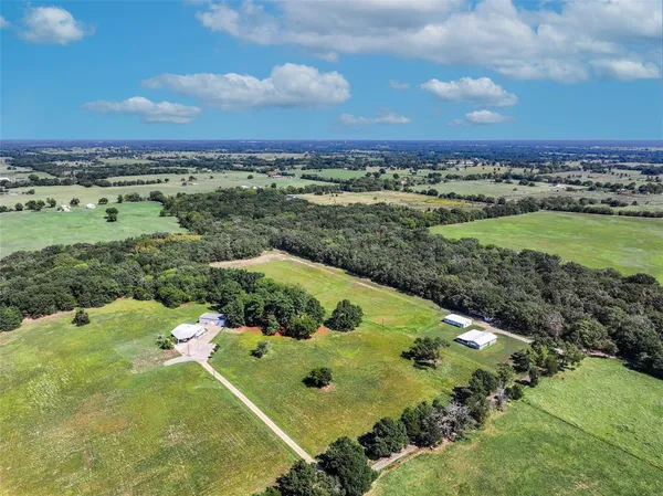an aerial view of a golf course with parking space
