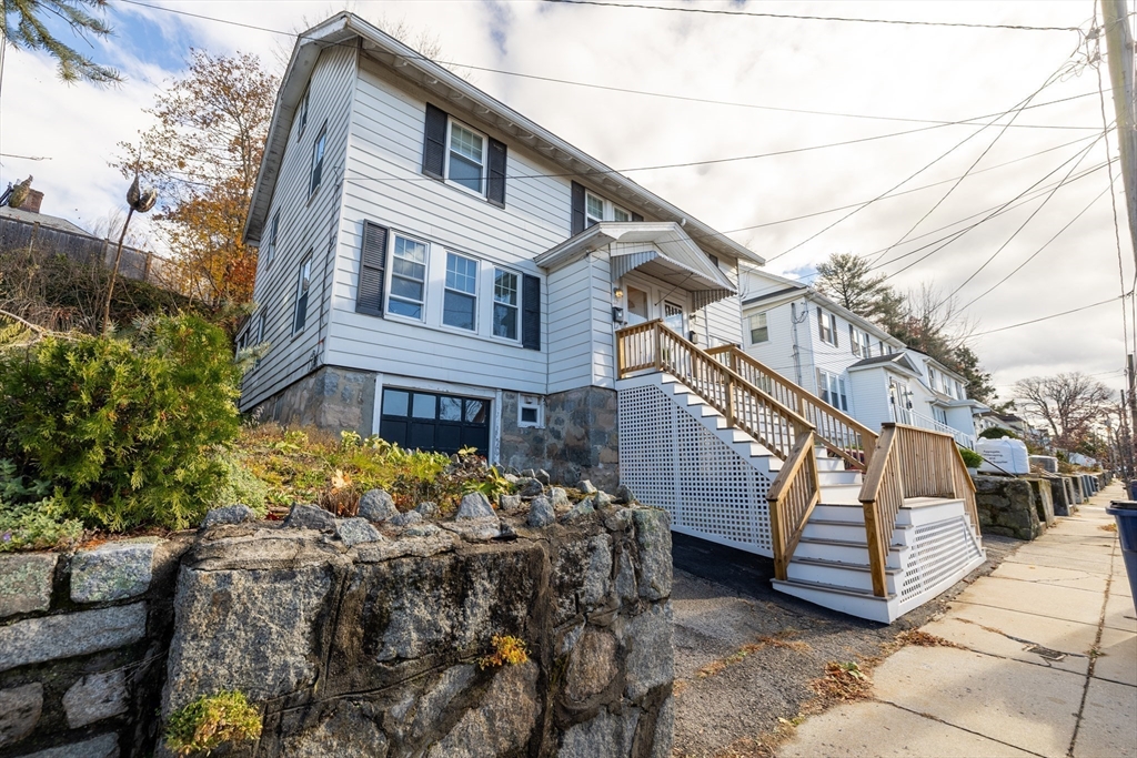22 Potomac Street, Unit 22 Boston, MA 02132 - Photo 11 of 12 a view of a house with a yard
