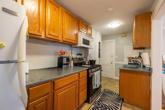 a kitchen with stainless steel appliances granite countertop a stove a sink dishwasher and a refrigerator