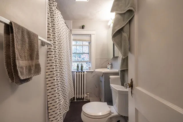 a white toilet sitting next to a bathroom sink