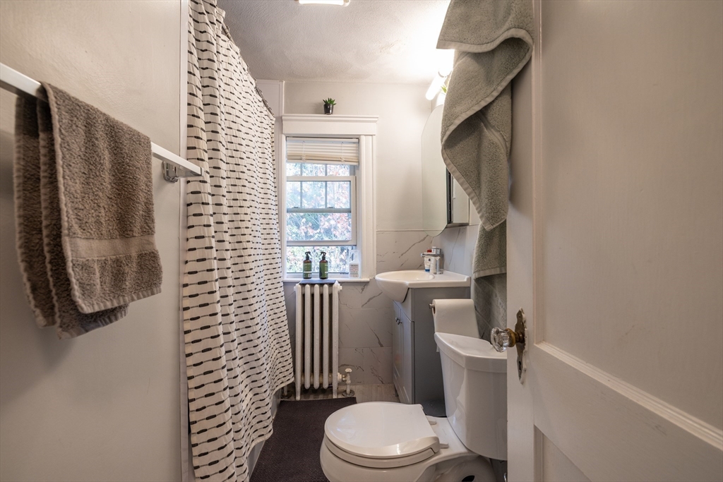 22 Potomac Street, Unit 22 Boston, MA 02132 - Photo 8 of 12 a white toilet sitting next to a bathroom sink