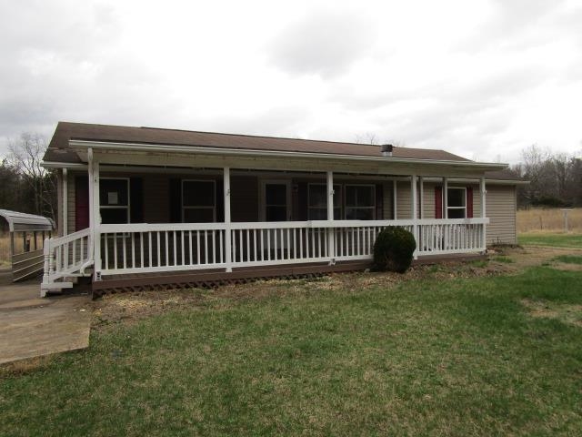a view of a house with a backyard