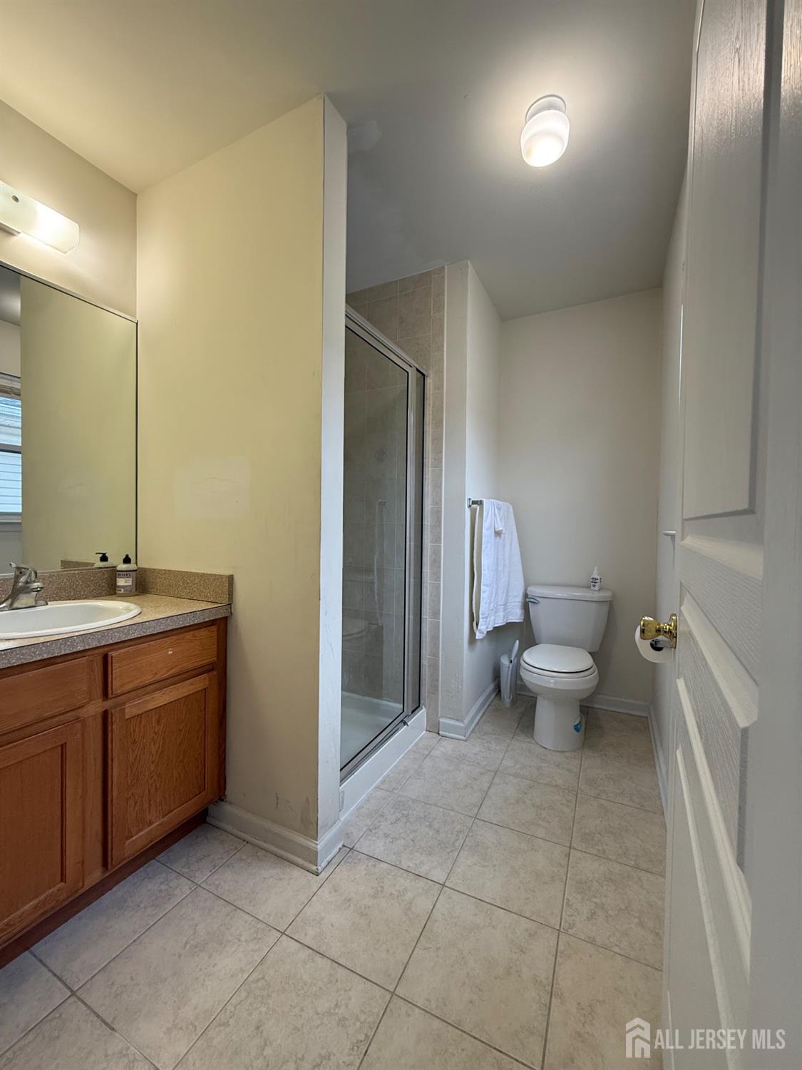 34 Mercer Street Carteret, NJ 07008 - Photo 17 of 17 a spacious bathroom with a double vanity sink a toilet and a mirror