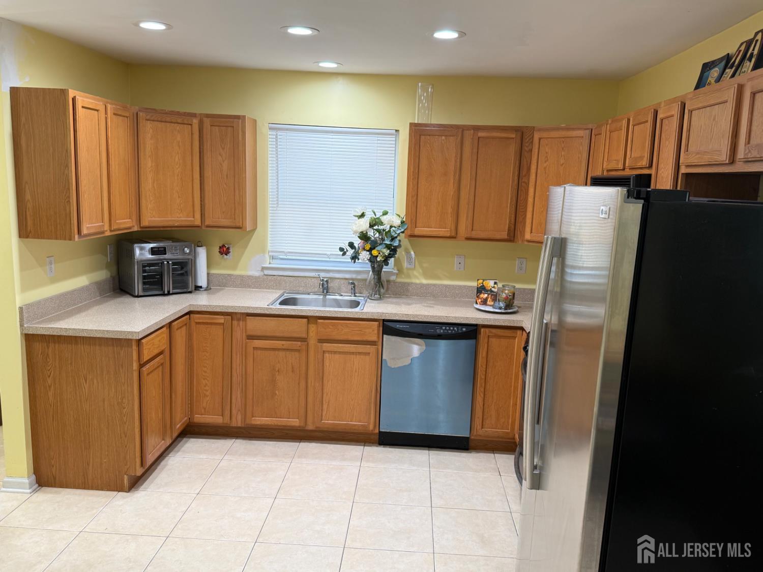 34 Mercer Street Carteret, NJ 07008 - Photo 5 of 17 a kitchen with stainless steel appliances granite countertop a refrigerator a sink and dishwasher
