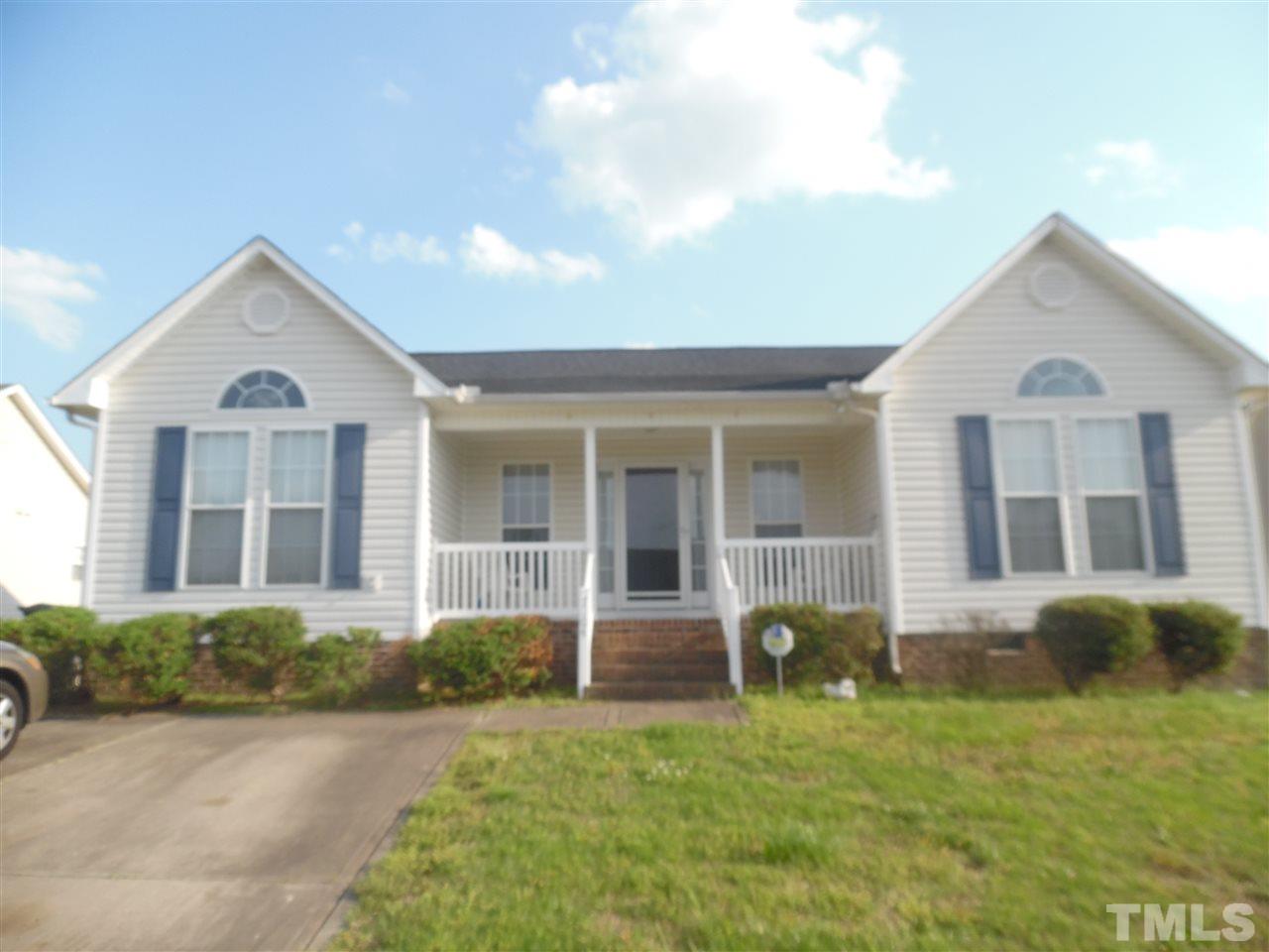 7104 Spanglers Spring Way Raleigh, NC 27610 - Photo 1 of 18 a front view of a house with garden