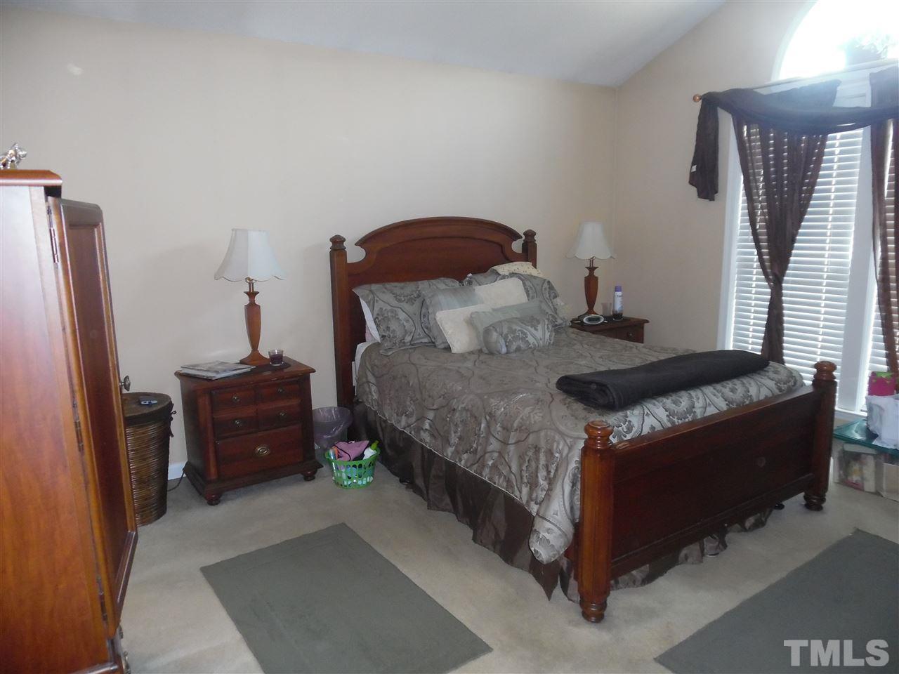 7104 Spanglers Spring Way Raleigh, NC 27610 - Photo 11 of 18 a bedroom with a bed and a dresser