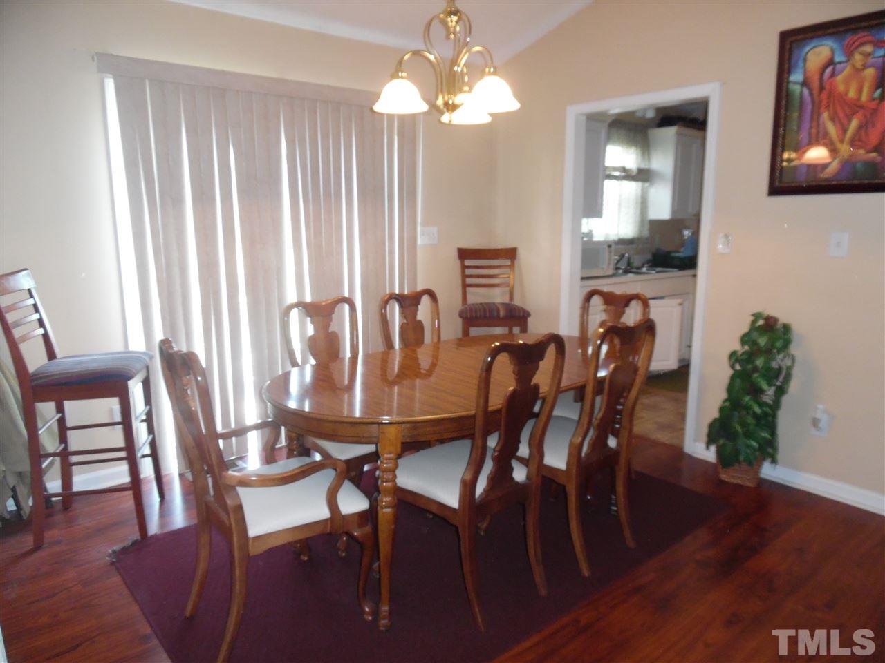 7104 Spanglers Spring Way Raleigh, NC 27610 - Photo 13 of 18 a view of a dining room with furniture window and wooden floor