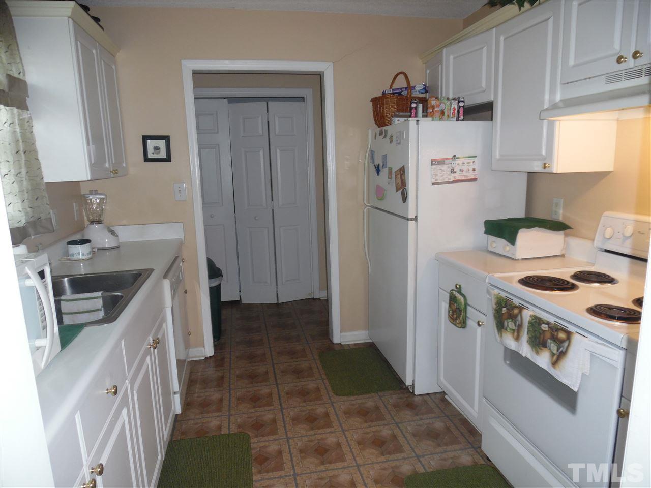 7104 Spanglers Spring Way Raleigh, NC 27610 - Photo 15 of 18 a kitchen with a stove a refrigerator and a sink