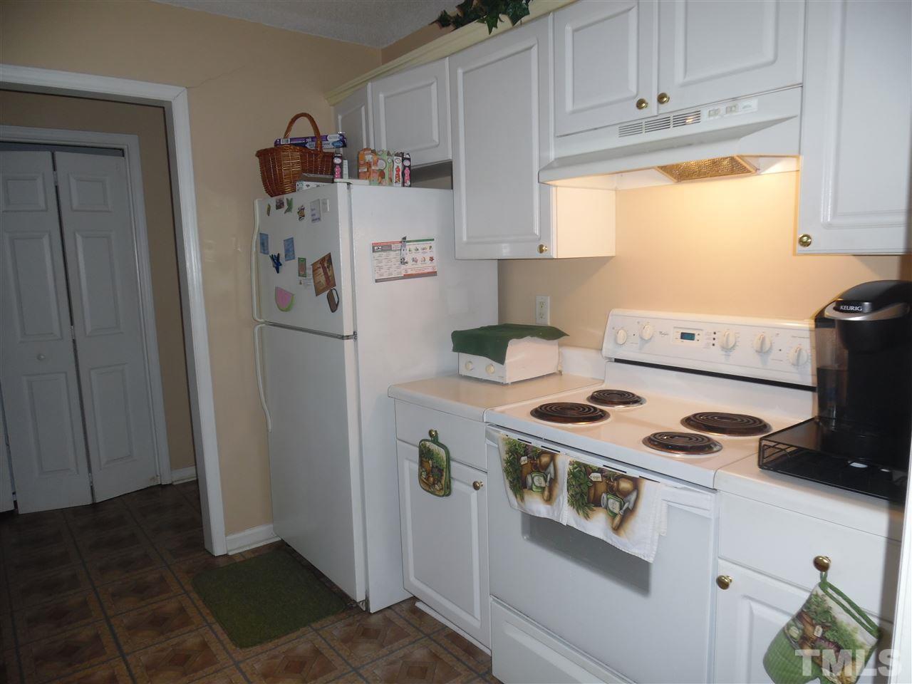 7104 Spanglers Spring Way Raleigh, NC 27610 - Photo 16 of 18 a kitchen with a refrigerator and a stove