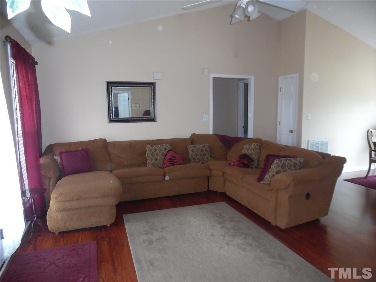 7104 Spanglers Spring Way Raleigh, NC 27610 - Photo 7 of 18 a living room with a couch and a bookshelf