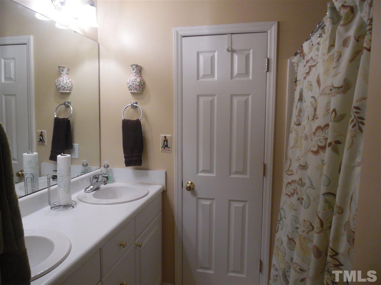 7104 Spanglers Spring Way Raleigh, NC 27610 - Photo 8 of 18 a bathroom with a sink double vanity and a mirror