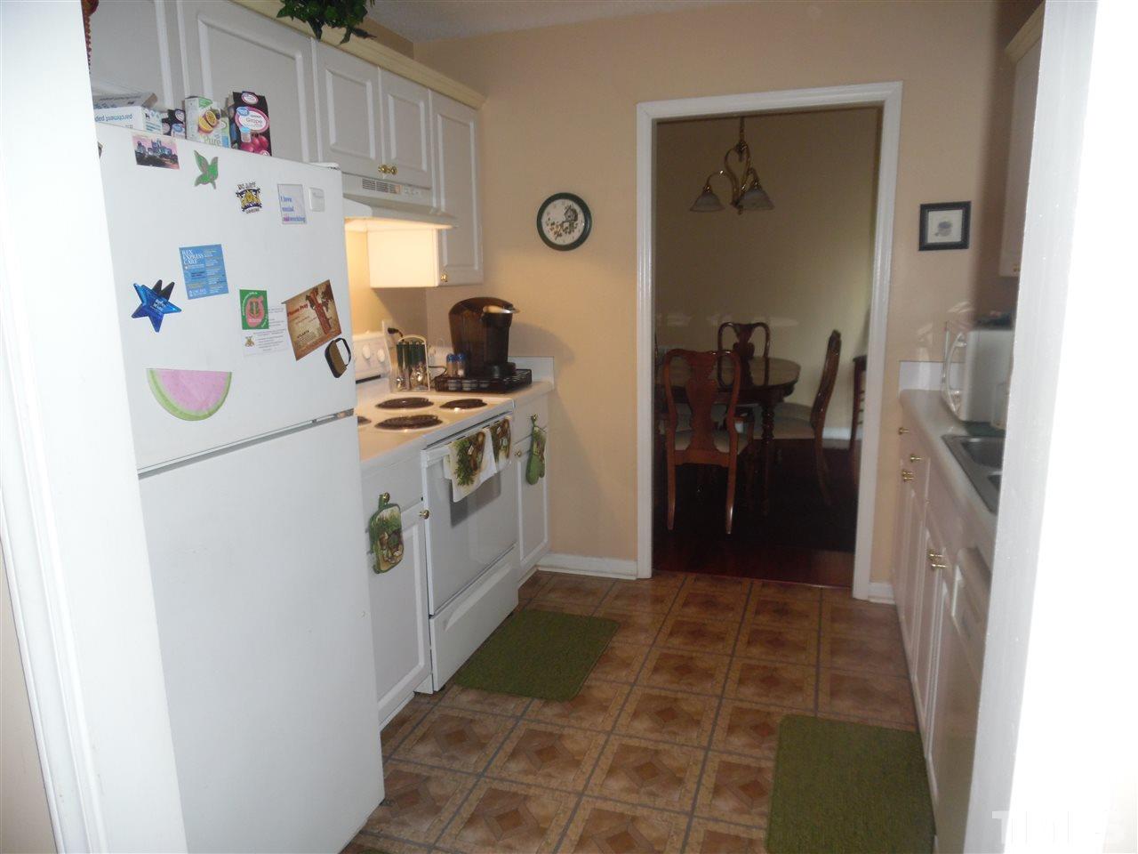 7104 Spanglers Spring Way Raleigh, NC 27610 - Photo 10 of 18 a kitchen with a refrigerator and a stove