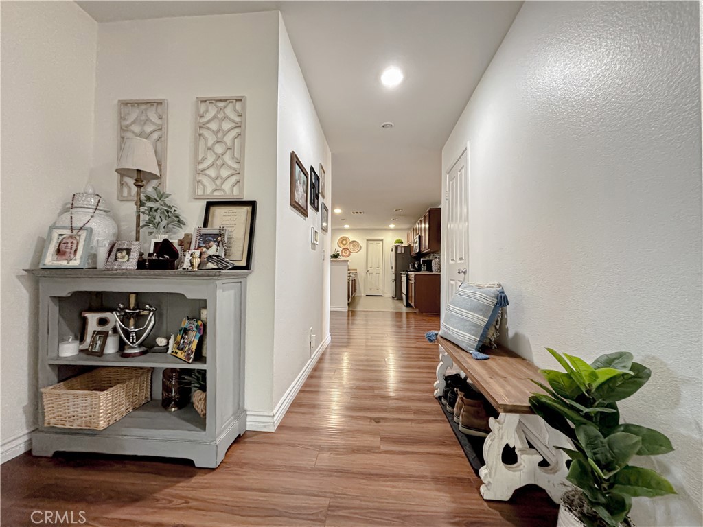3345 James Court Lancaster, CA 93535 - Photo 12 of 29 a hallway with a dining table with wooden floor