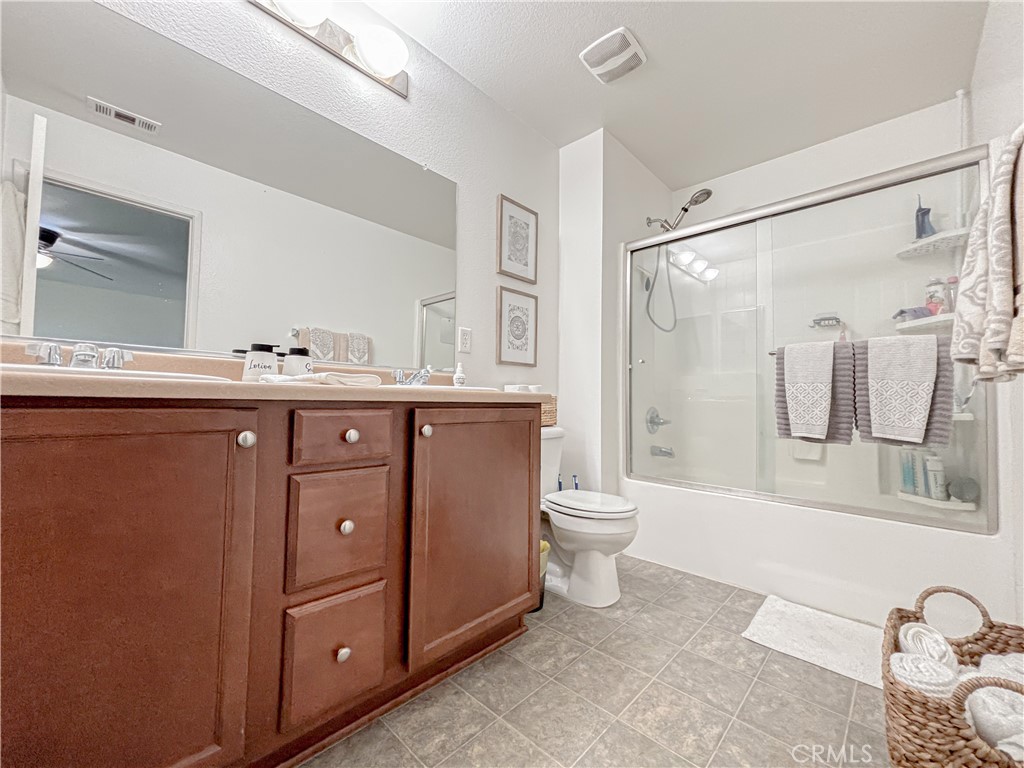 3345 James Court Lancaster, CA 93535 - Photo 16 of 29 a bathroom with a granite countertop sink toilet and shower