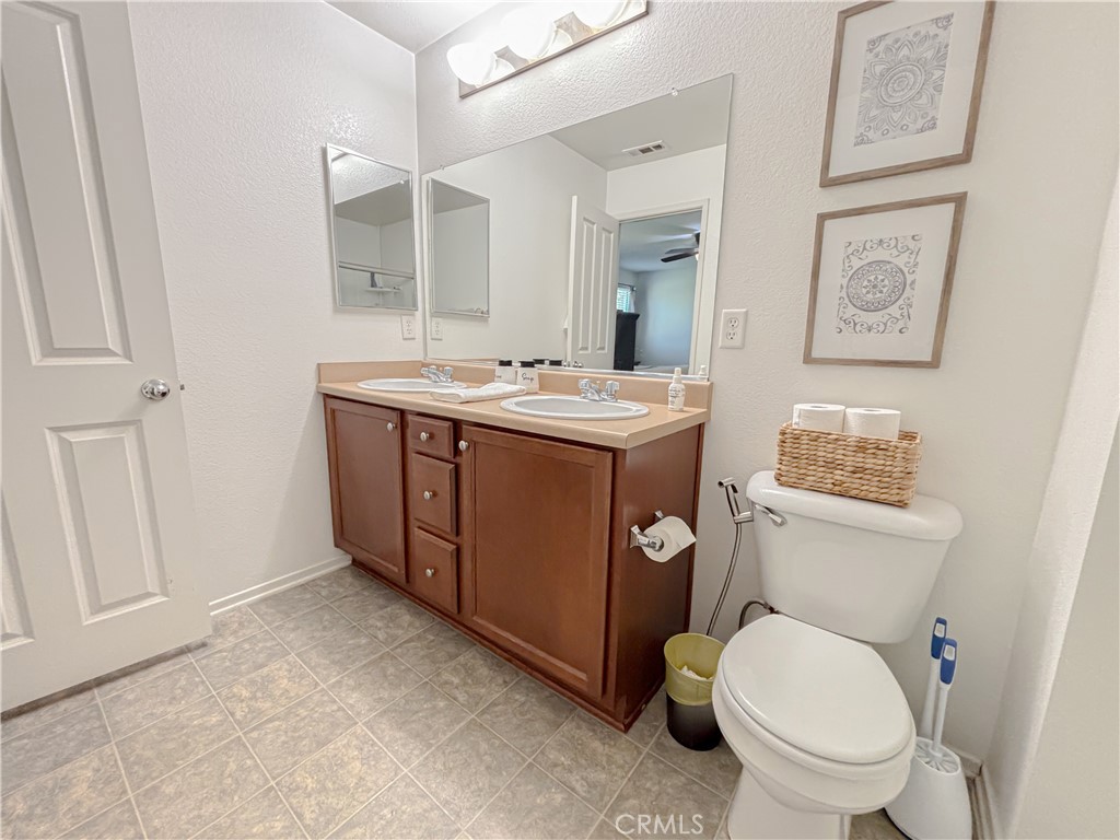 3345 James Court Lancaster, CA 93535 - Photo 17 of 29 a bathroom with a toilet sink and mirror