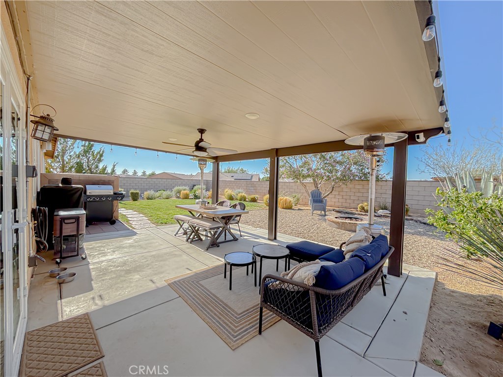 3345 James Court Lancaster, CA 93535 - Photo 26 of 29 a living room with patio furniture and a floor to ceiling window