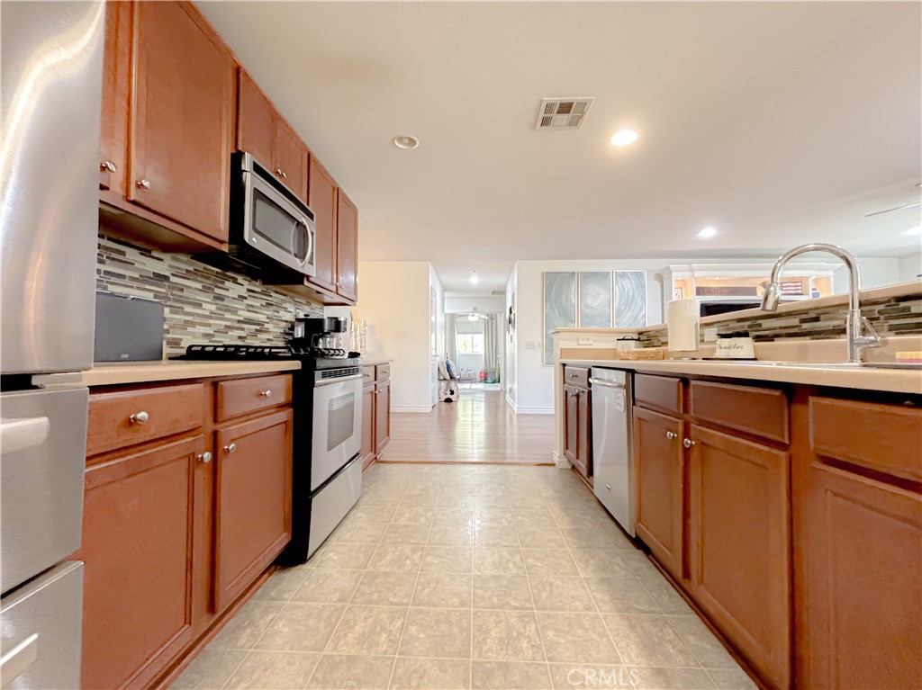 3345 James Court Lancaster, CA 93535 - Photo 8 of 29 a kitchen with stainless steel appliances granite countertop a sink and cabinets